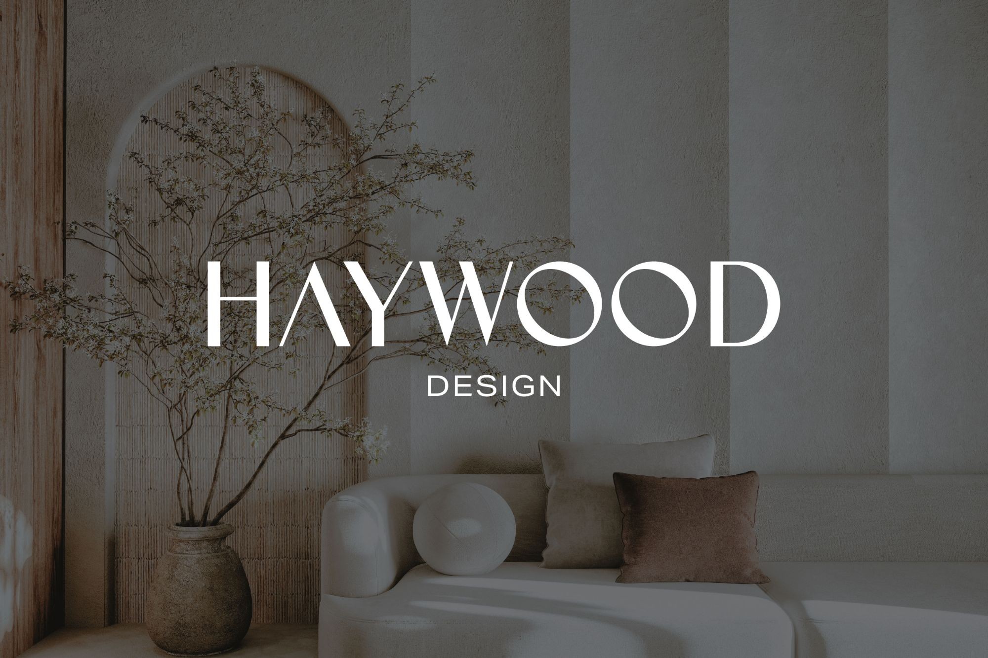 The Haywood Design wordmark over a softly lit lobby seating area