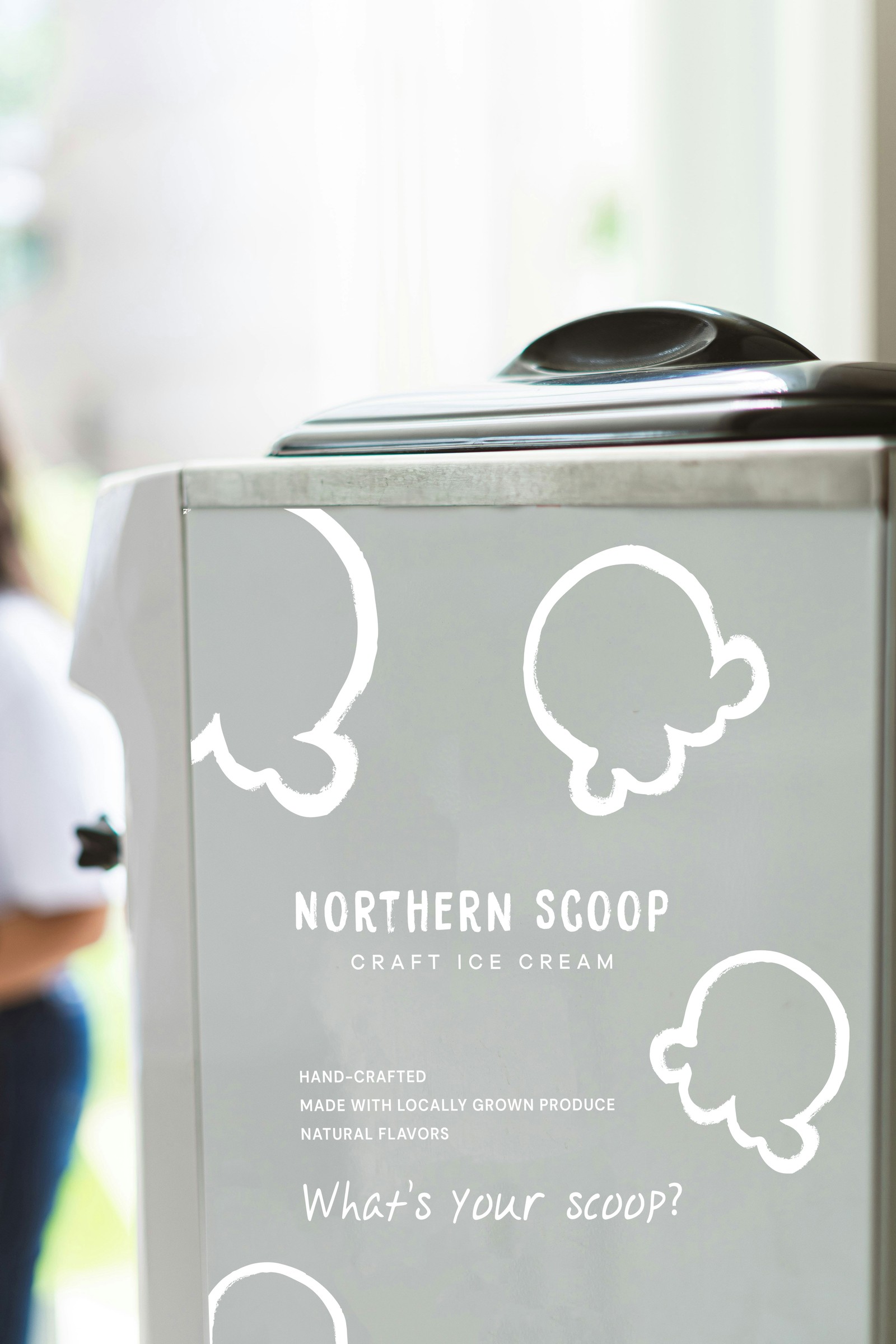 A close-up of the Northern Scoop retail cart's painted side panel